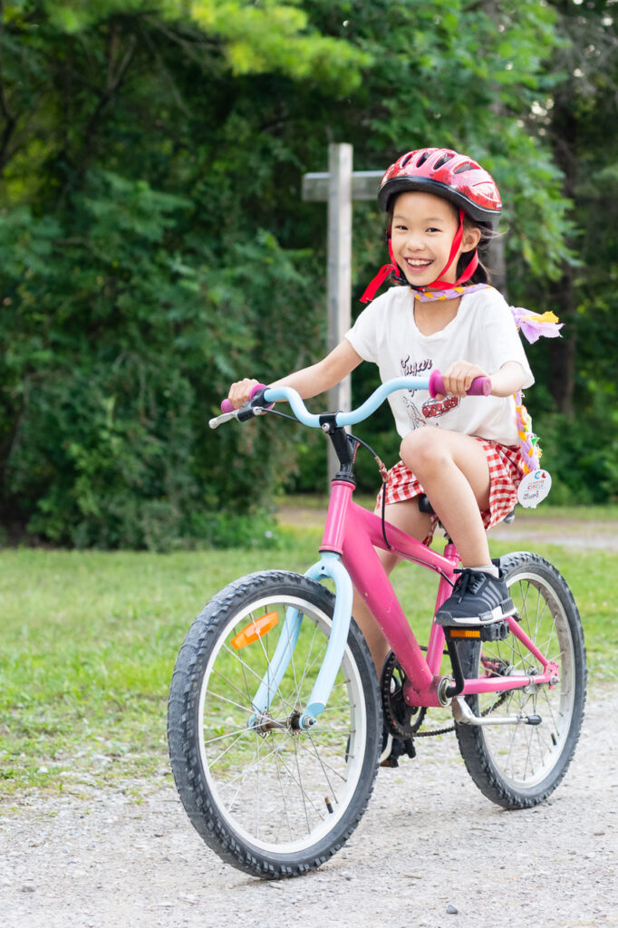 nori riding a bike at camp