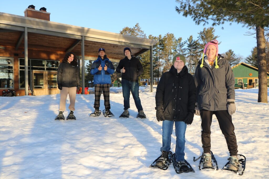 traci and volunteers in snowshoes outside in the snow