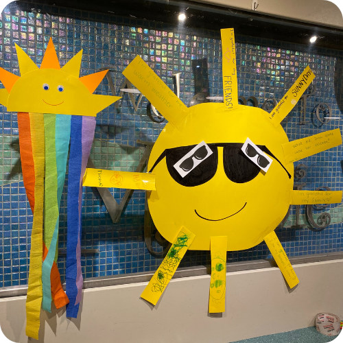 cardboard artwork of the sun and a rainbow hanging from ceiling in the hospital