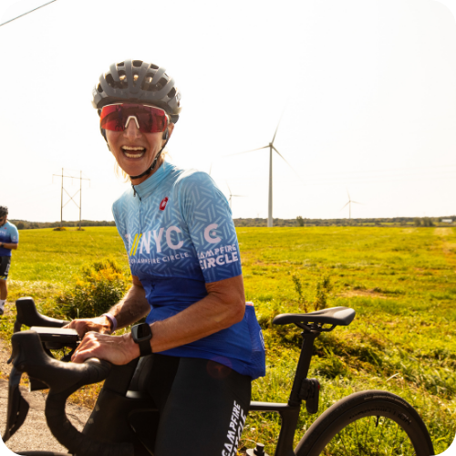 elise standing with her bike on a break from riding