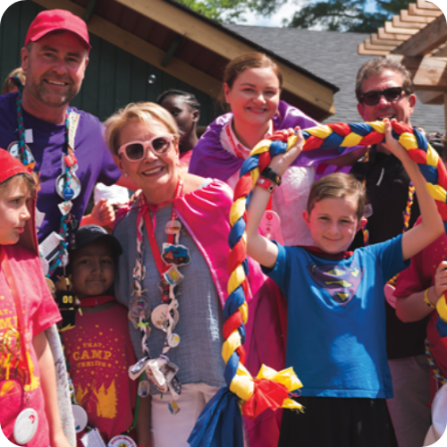 emmanuelle and alex with campers in costumes at camp