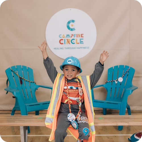 carter wearing hard hat and construction gear with campfire circle sign overhead