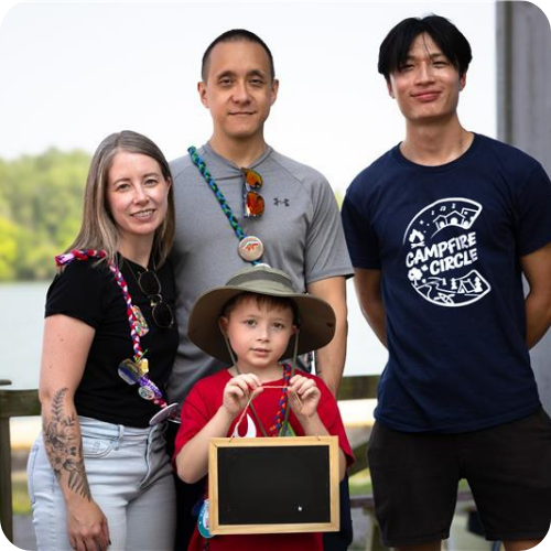 mo family with volunteer at camp