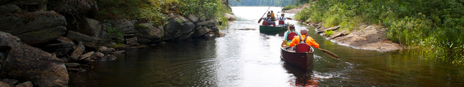 campers in canoes on the lake