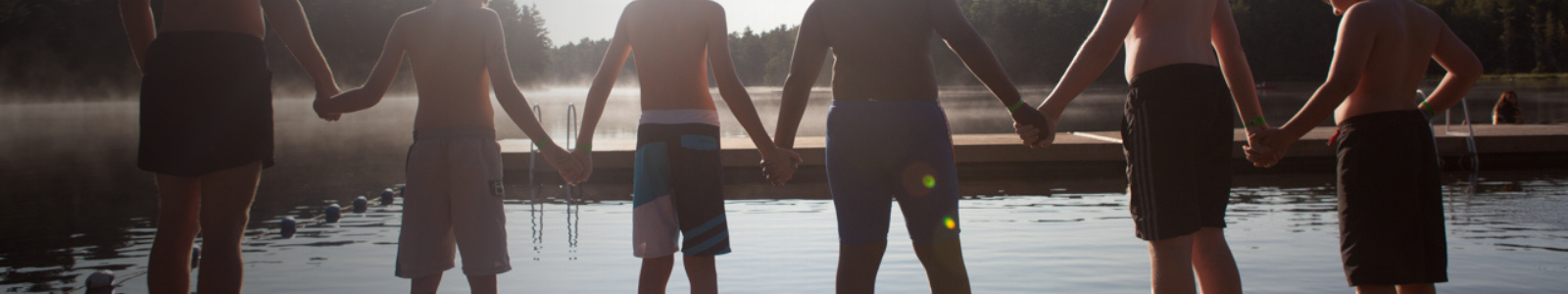 campers holding hands on the dock at camp