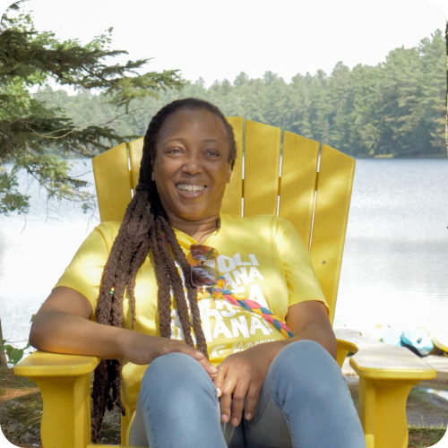 judy on a camp chair with lake in background
